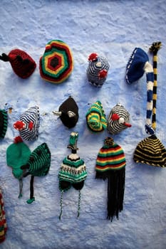 Rasta hats on a blue wall in Chefchaouen, Morocco