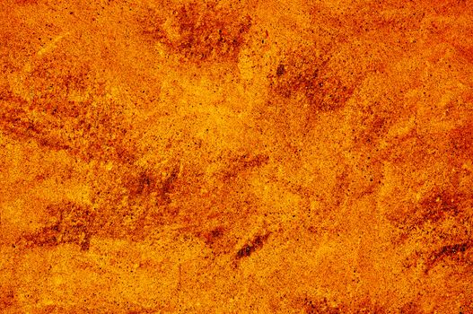 closeup of a rough wall in brown and orange.