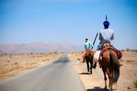 Moroccan riders on the road to marrakech close to the city of Tata in Morocco