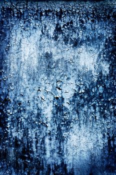 Closeup of a grungy wooden door in blue.