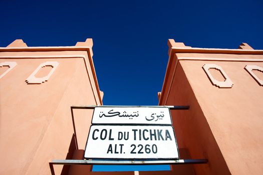 Moroccan architecture and sign board at the col du tichka pass in the atlas mountains in morrcco with blue sky