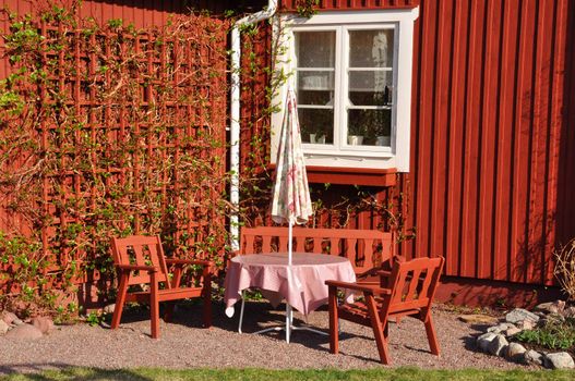 A set of garden furniture in a rural milieu in sweden.