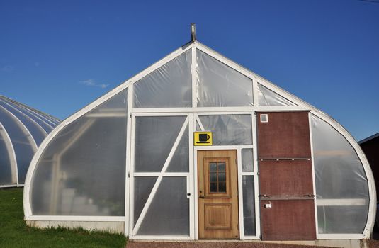 Greenhouse with a coffe cup sign.