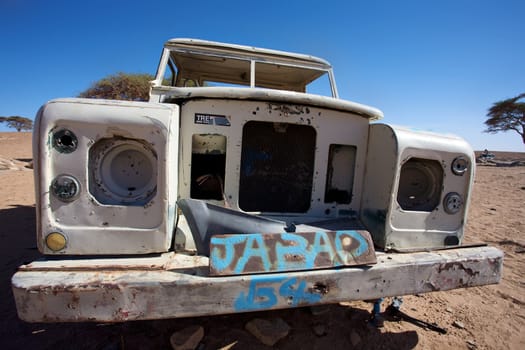 In the desert of Morocco, merzouga, old car left in the desert