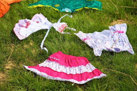 Clothes drying and laying on the green grass