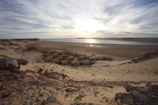 Coast of Southern Morocco with the Atlantic Ocean and a few bungalows with the desert all around