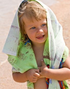 portrait of little girl with green towel