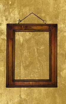 Old wooden frame hanging on a grungy wall.