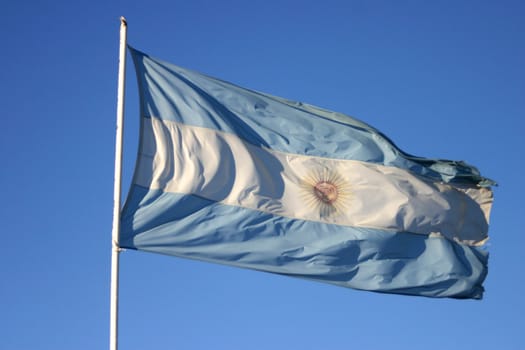 Flag of Argentina with a clear blue sky shoot in Patagonia