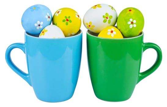 Polka dot easter eggs in cups on white background