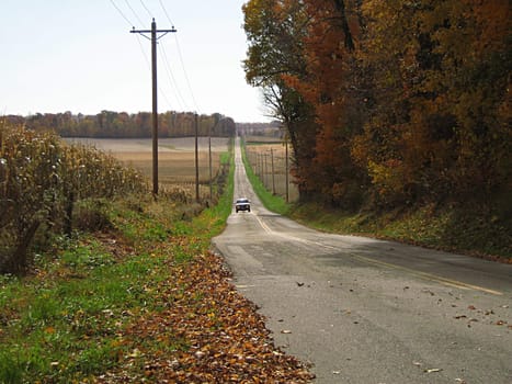 A photograph of a truck traveling on a road.