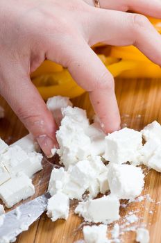 Preparation of salad from cheese and fresh vegetables