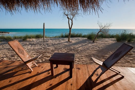 Terrace with wooden chairs, overlooking the lagoon