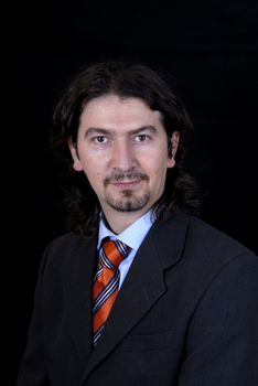 young business man portrait on black background