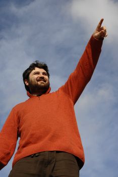 young casual man with the sky as background