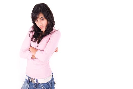 Young girl with arms crossed and angry attitude over white background with copy space.