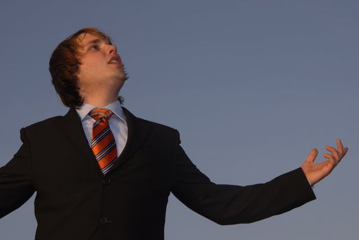 man with open arms with the sky as background