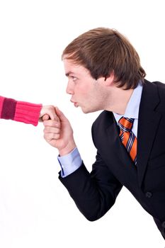 Young man with suit and tie, kissing a lady's hand.