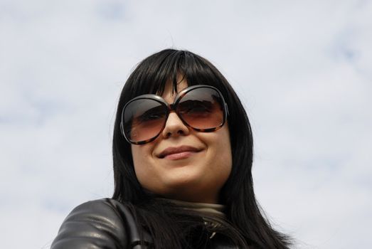 young woman portrait with the sky as background