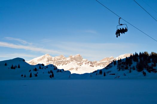 Skiers on Ski Lift, on the Swiss Alps.