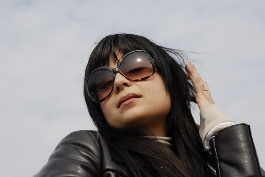 young woman portrait with the sky as background