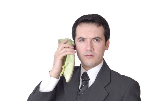 young business man calling with a shoe isolated on white