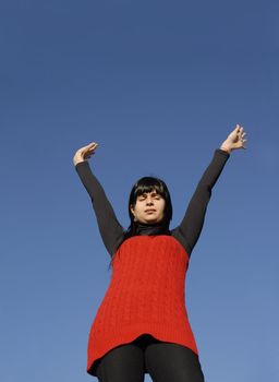 young woman at the sun with the sky as background