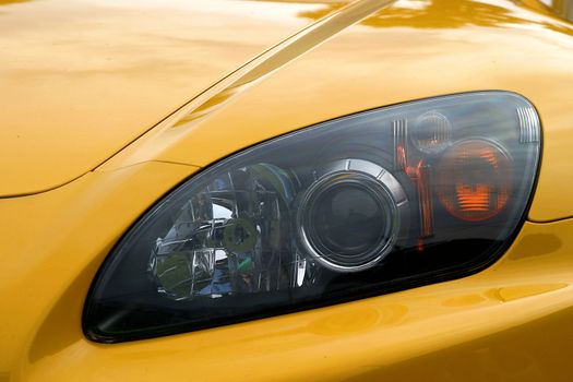 Head light of a yellow sports car
