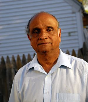 Portrait of an old Indian man on a natural background