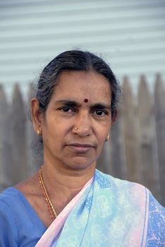 An old indian woman smiling in the summer sun