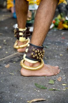 thaipusam devotee wearing a bracelet of bells and gold