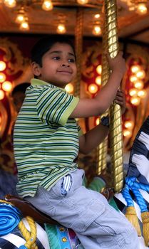 An handsome indian kid having fun at a local carnival