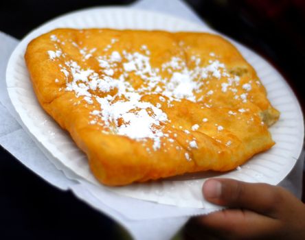 A plate of fried dough at a local carnival