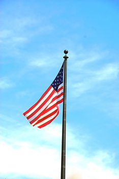 An American Flag flying on a clear sunny day