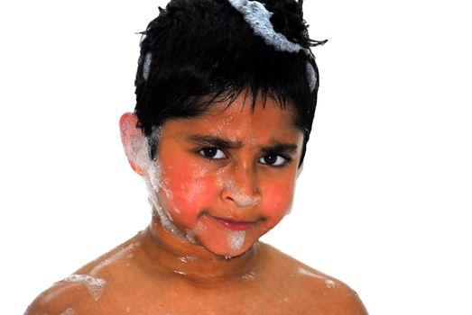 Unhappy child taking a bubble bath