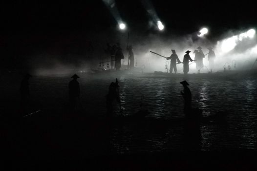 A group of fisherman fishing at night