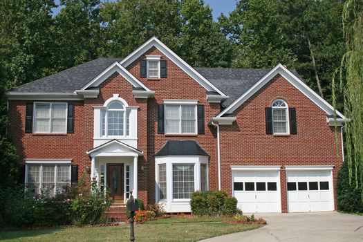 A nice brick house against a blue sky