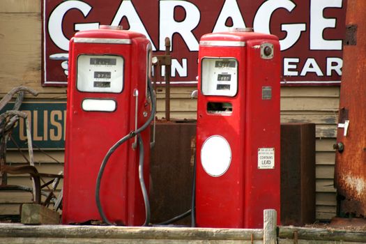 Two red vintage gas pumps