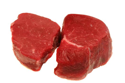 Two prime filet mignon steaks ready for grilling isolated on white