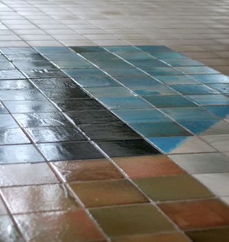 Ceramic tile floor with interesting pattern fading into the distance