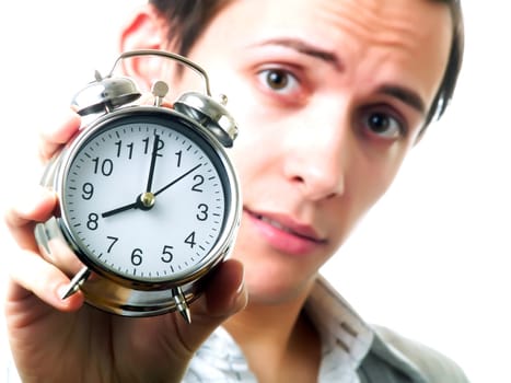 Young man holding an alarm clock