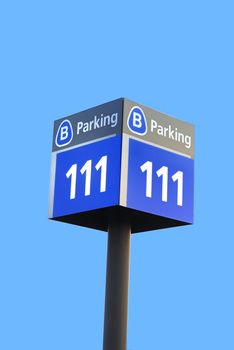 A parking sign board isolated against a clear blue sky