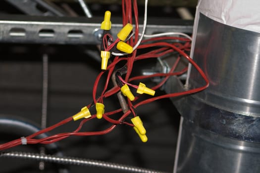 Exposed Electrical Wiring Harness with red wires and yellow connectors. Very nice contrast between the colors in the composition.
