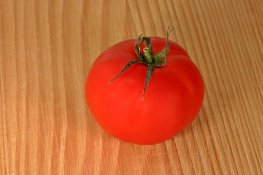 Tomato on wooden board