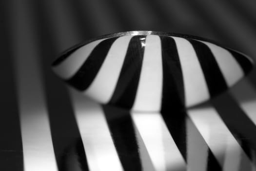 Macro of teaspoon with stripped reflection