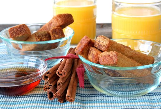 French toast sticks, with fresh oj, cinnamon sticks, and syrup.