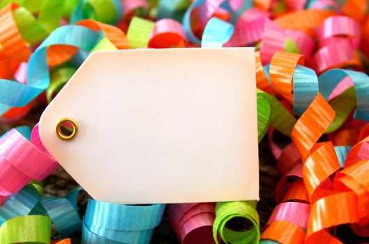 Colorful ribbons surrounding a blank tag.