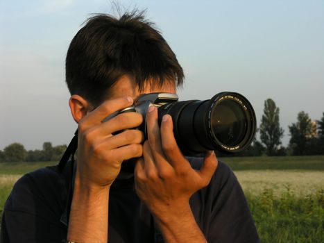 Man photographing with dSLR camera