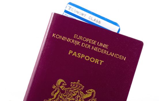 Economy plane ticket in dutch passport isolated on white.
