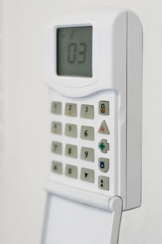 security system console, mounted on a wall, shallow DOF